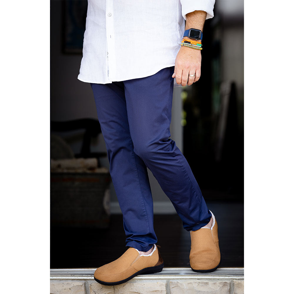 PowerStep Orthotic Arch Supporting slippers for Men, man stepping outside in orthotic arch supporting slippers 